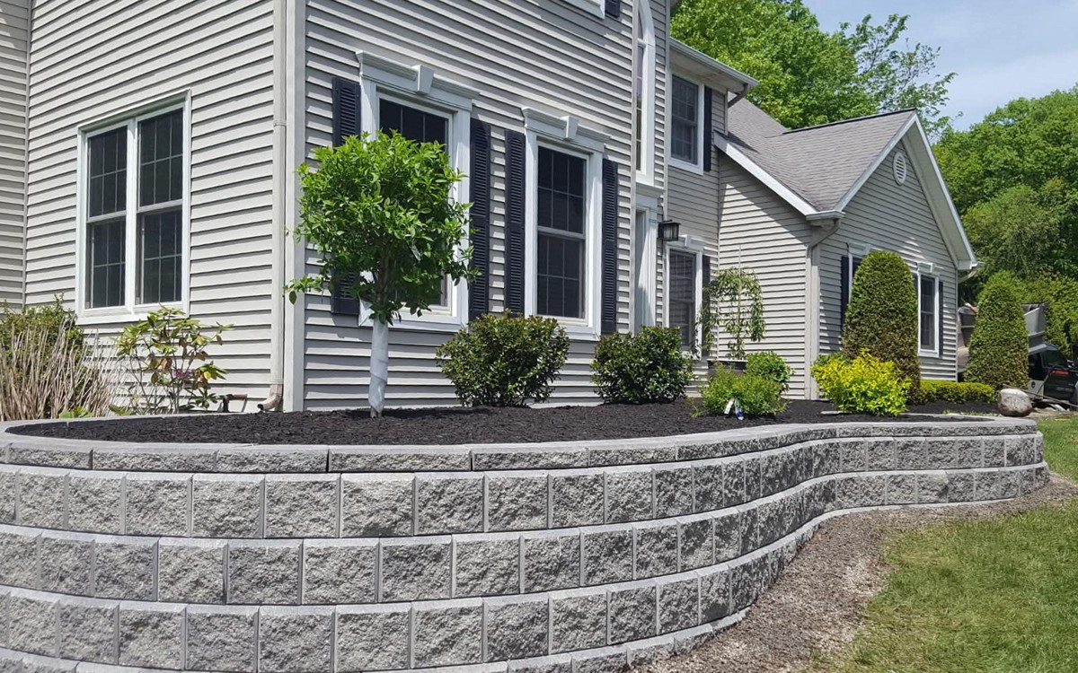 Curved retaining wall with landscaping — wide view