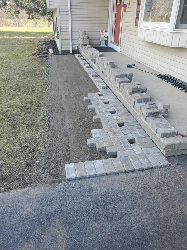 Paver installation in progress at ranch house