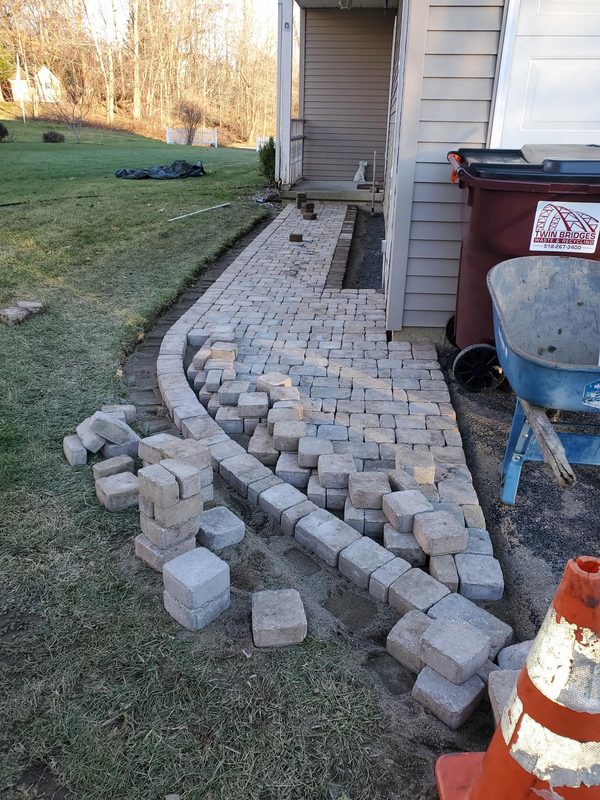 Side walkway paver installation in progress