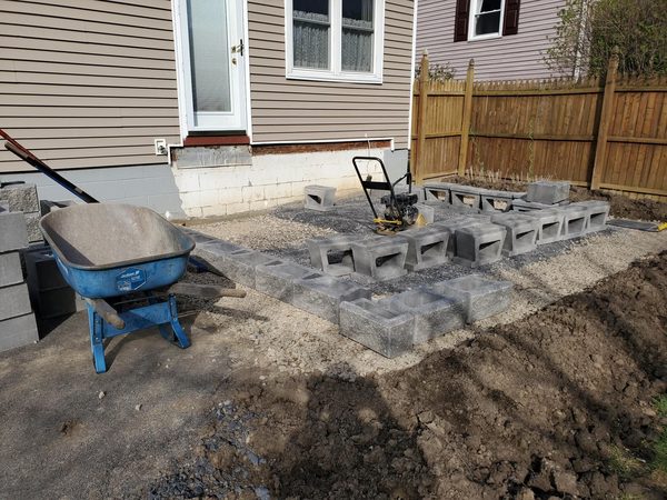 Cinder blocks being laid for retaining wall