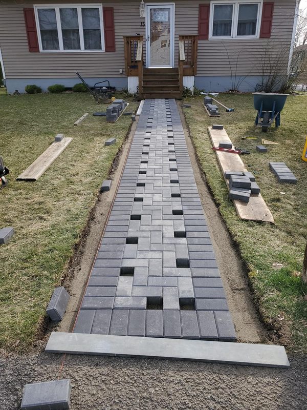 Walkway pavers nearly complete in herringbone pattern