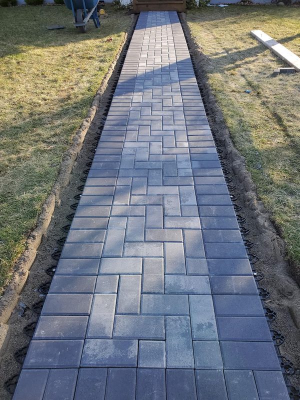 Completed herringbone paver walkway leading to front door