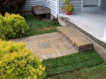 Small patio with retaining wall and plantings