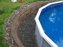 Retaining wall surrounding an above-ground pool