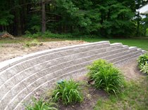 Curved retaining wall with steps and plantings